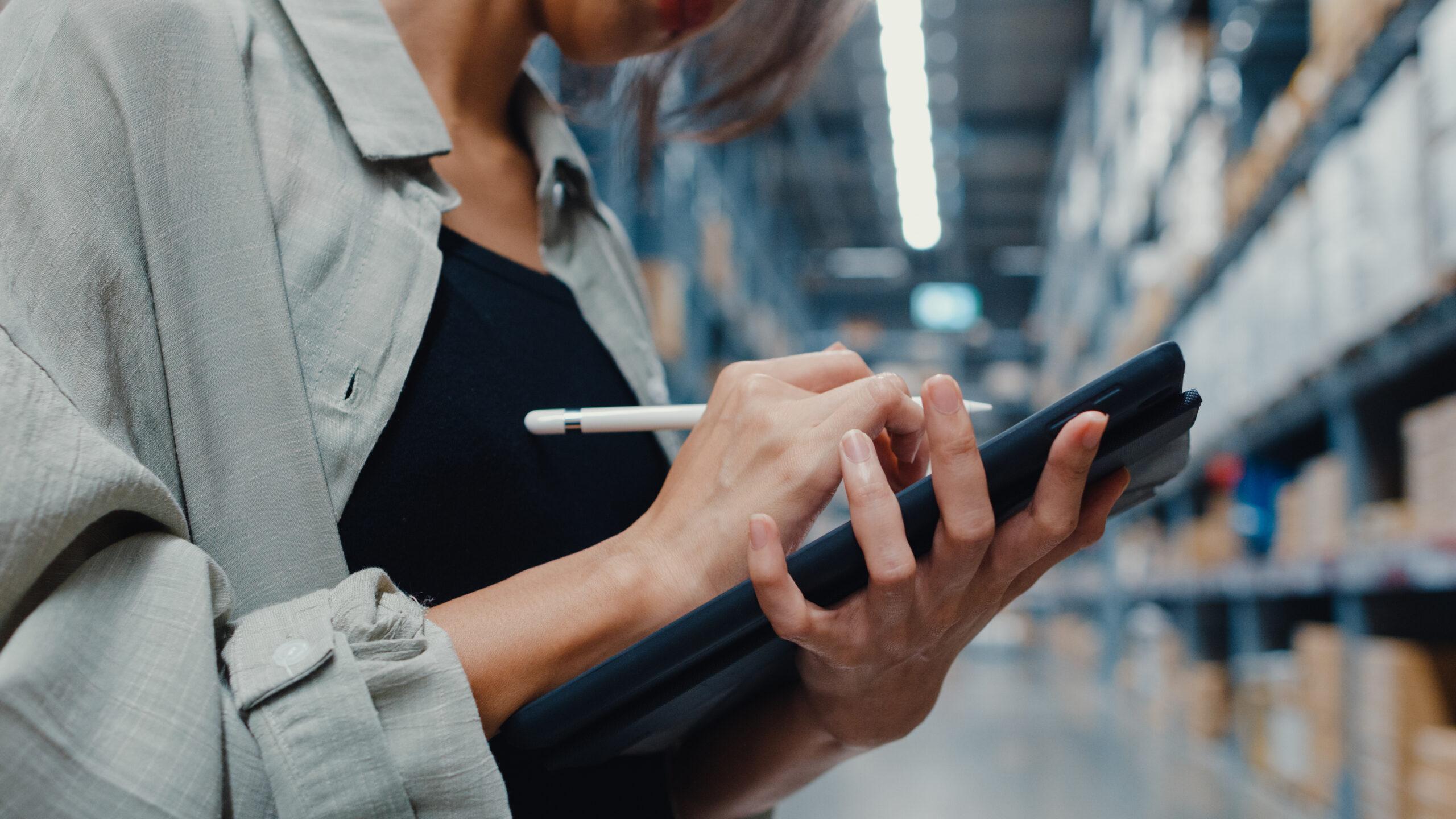 Female warehouse manager checking inventory