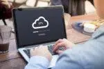 Businessman doing cloud uploading using laptop