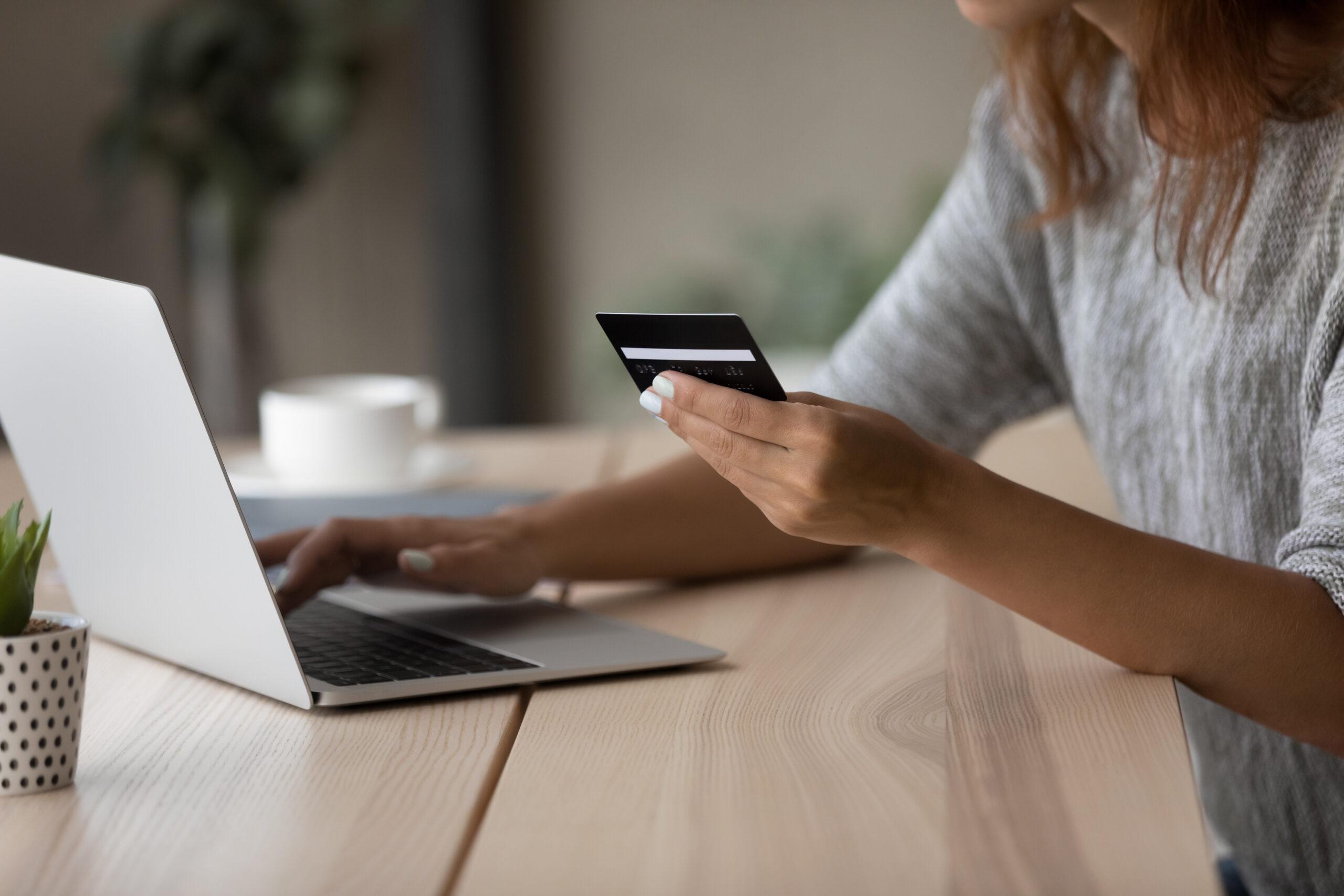 Young woman entering payment information from credit card