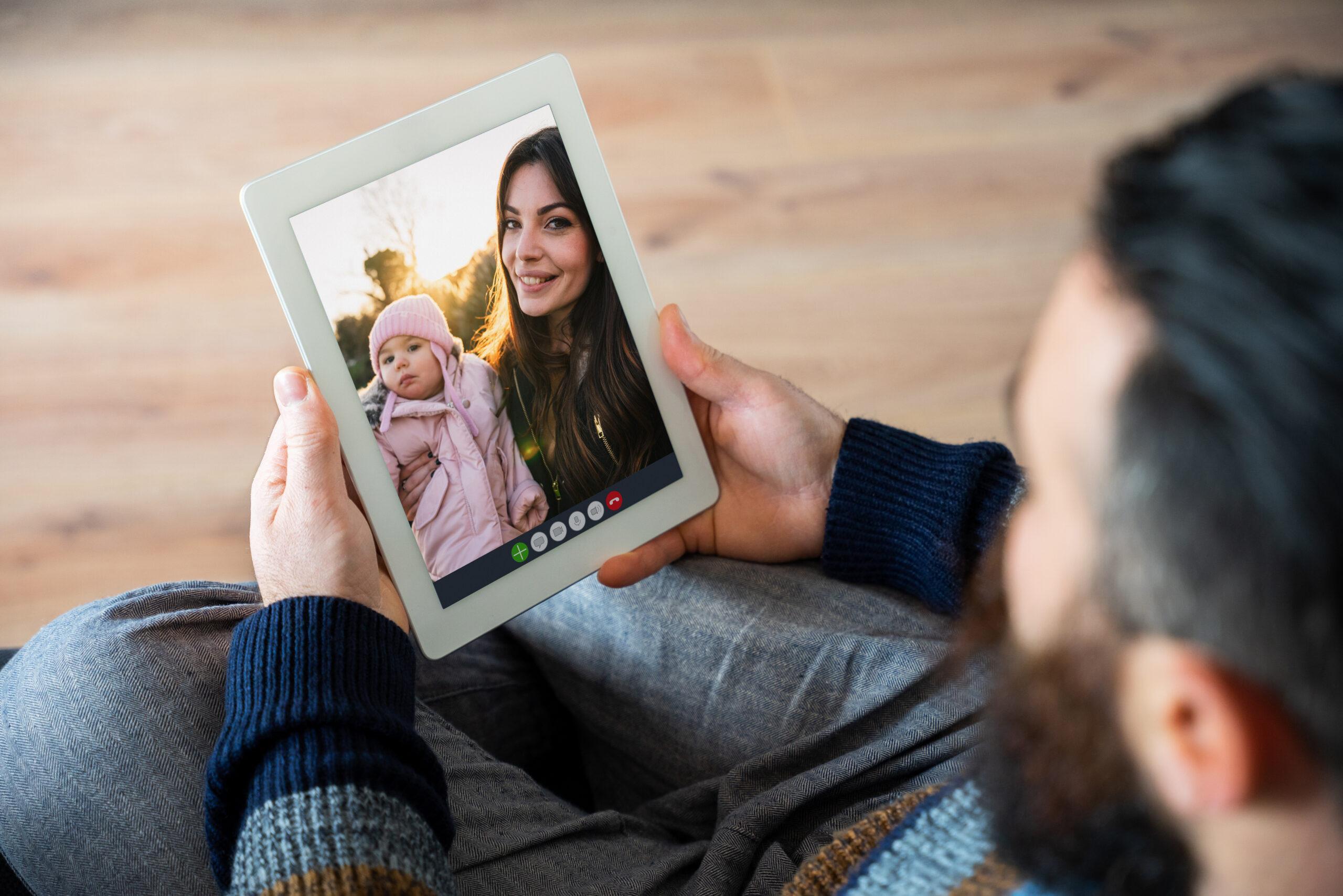 Dad talking to wife and baby on a video call