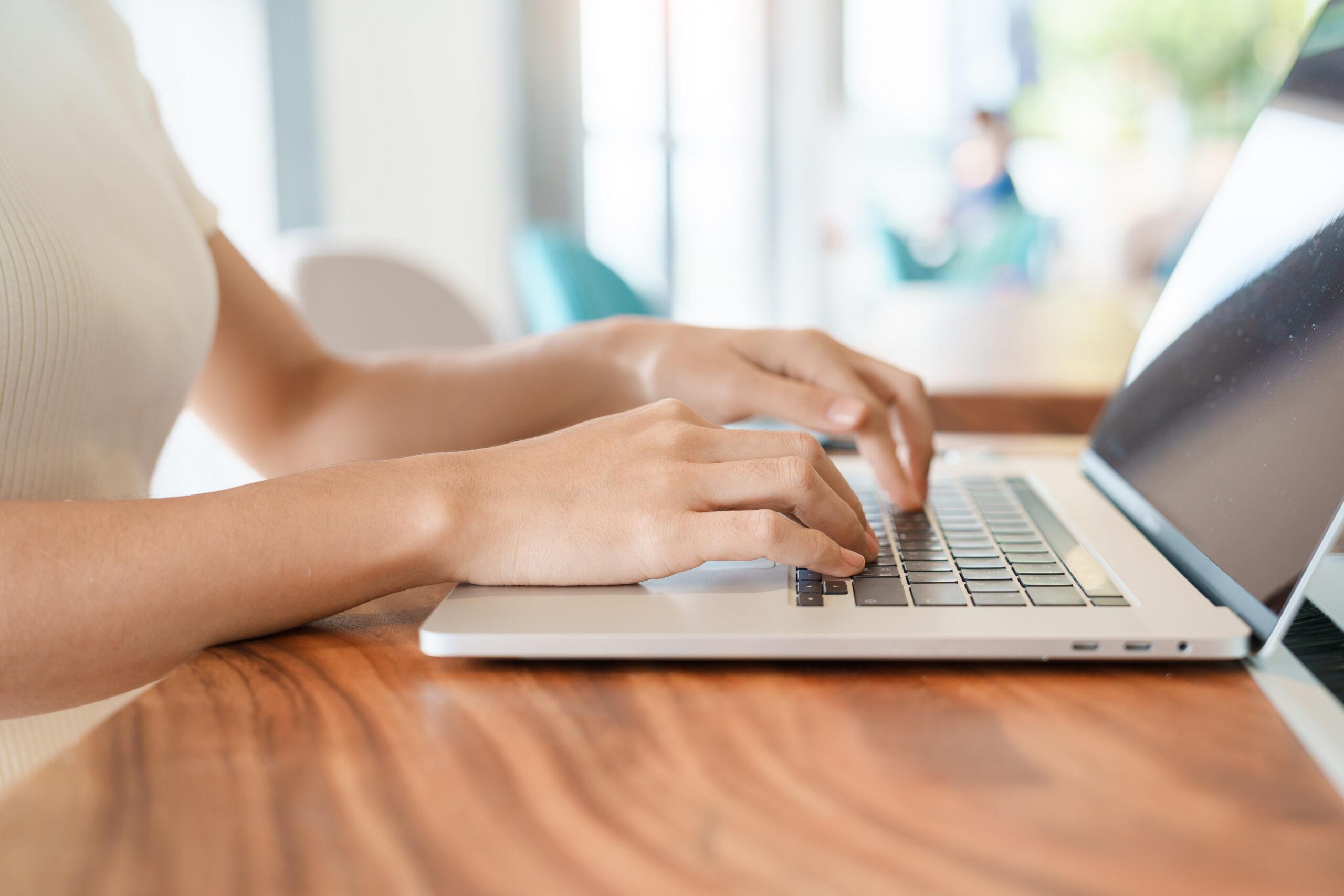 Woman (only hands visible) using laptop