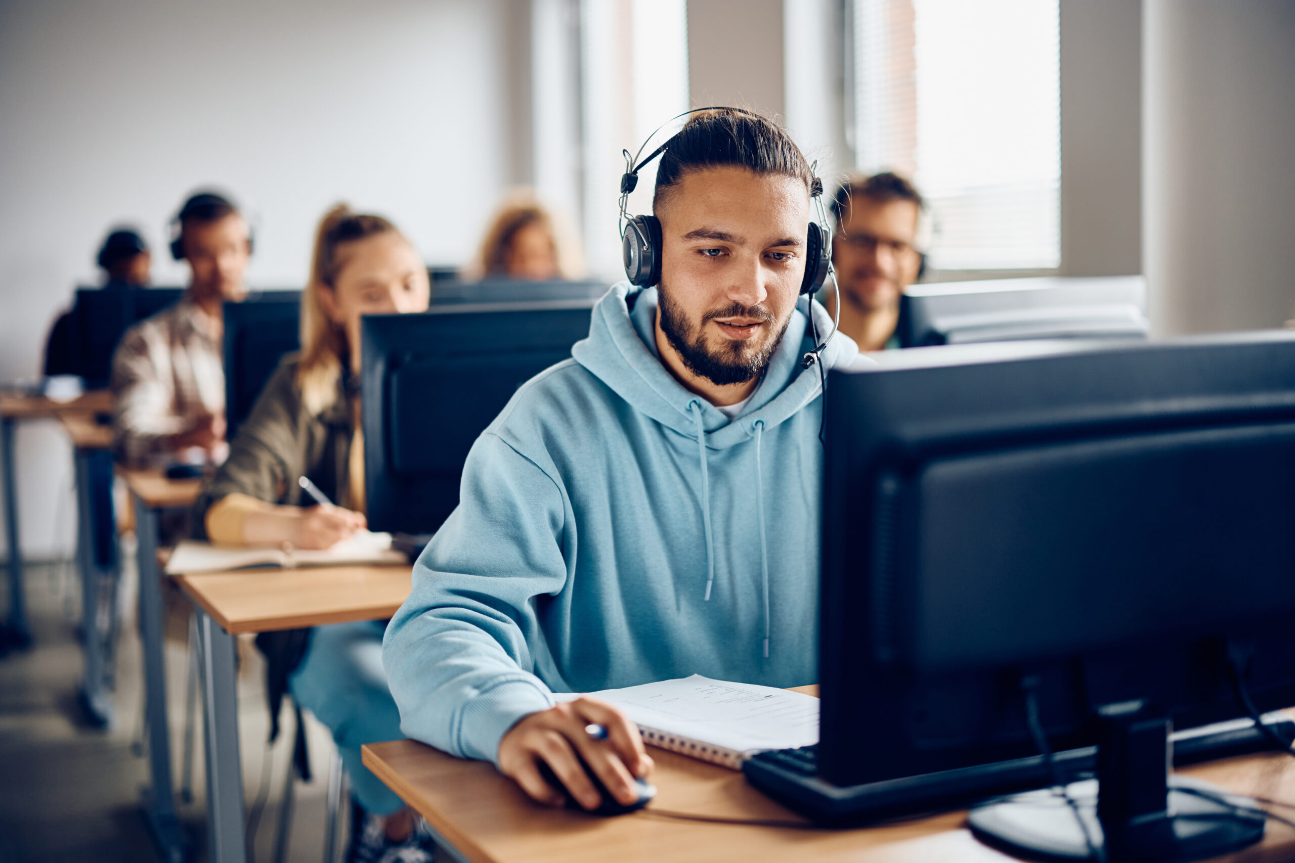 Young student learning on computer at university classroom