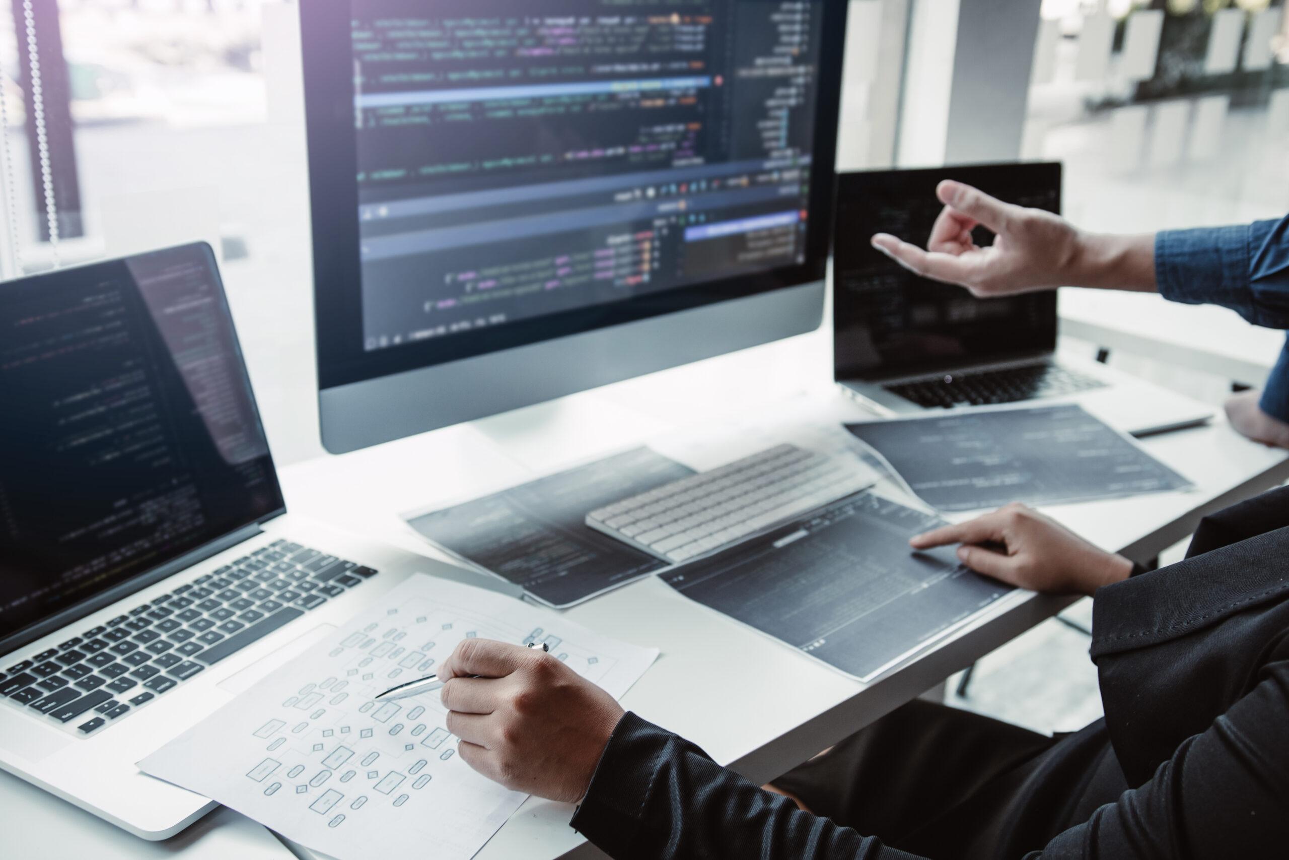 Colleagues working on the development of programming and encryption technology website design programmers on desk in office