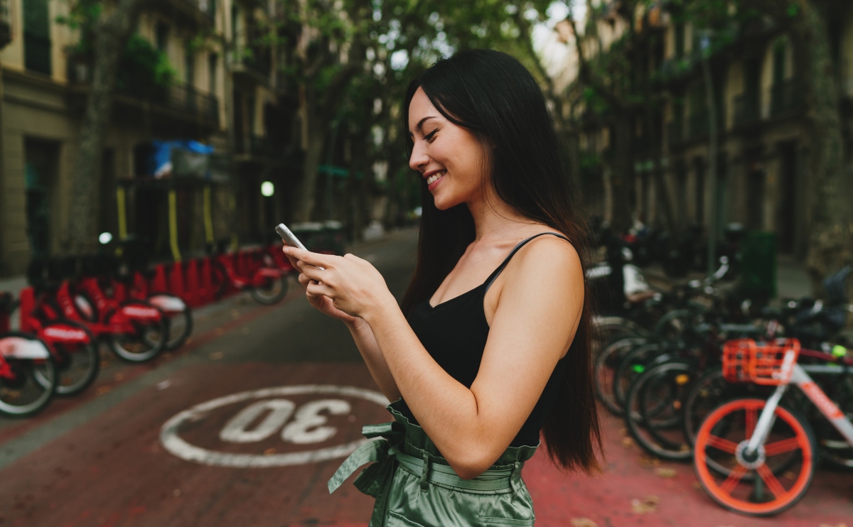 Woman with long black hair checking her phone 
