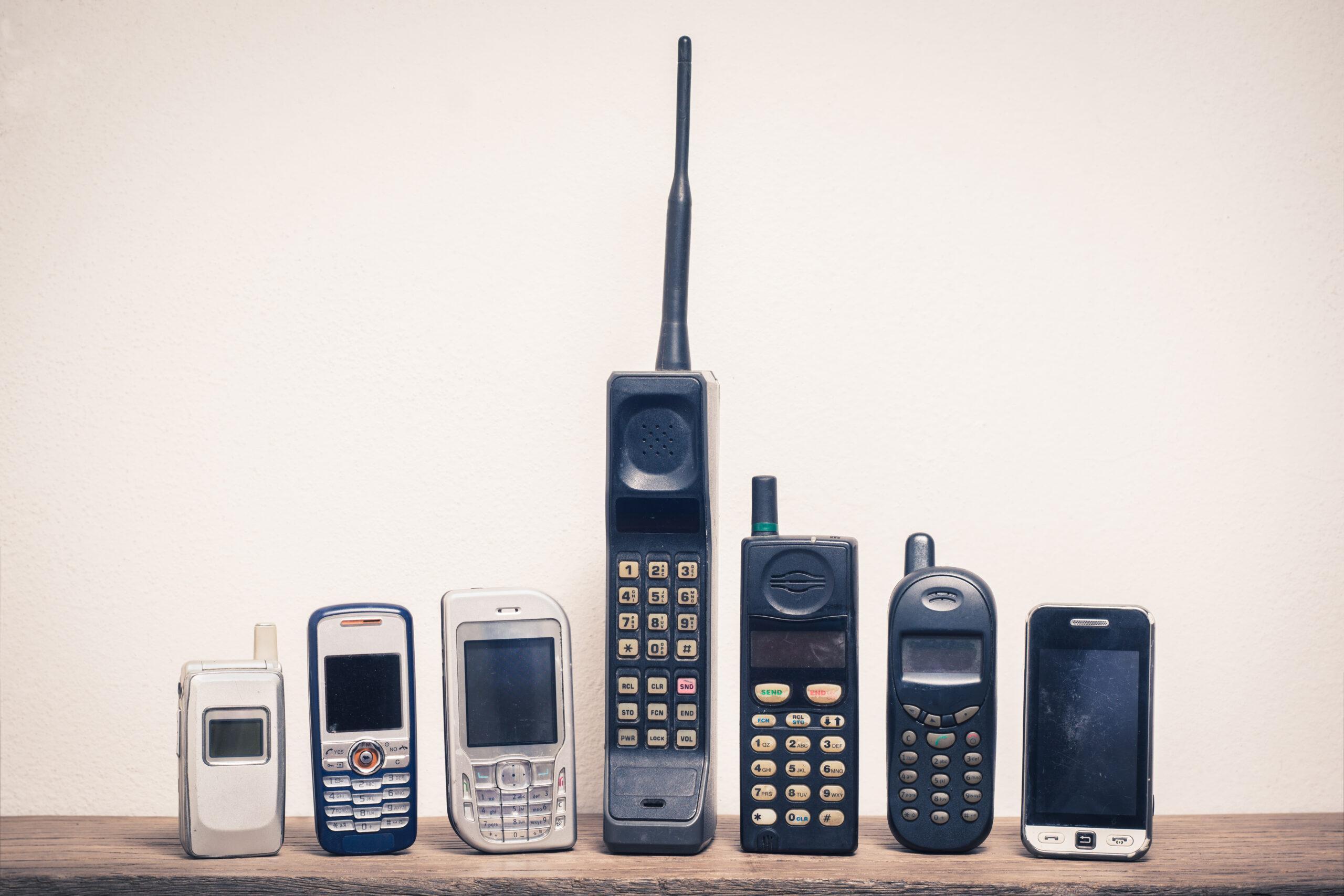 Group of old and obsolete mobile phone or cell phone on old wood