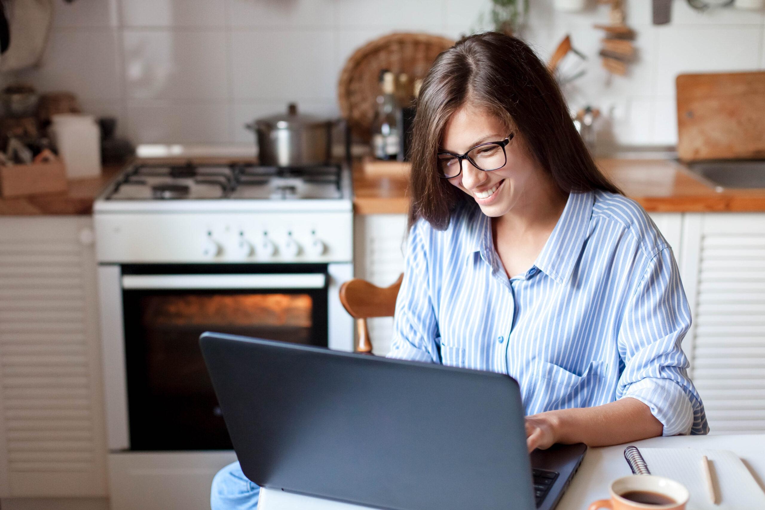 Young woman with glasses and long hair working from home office