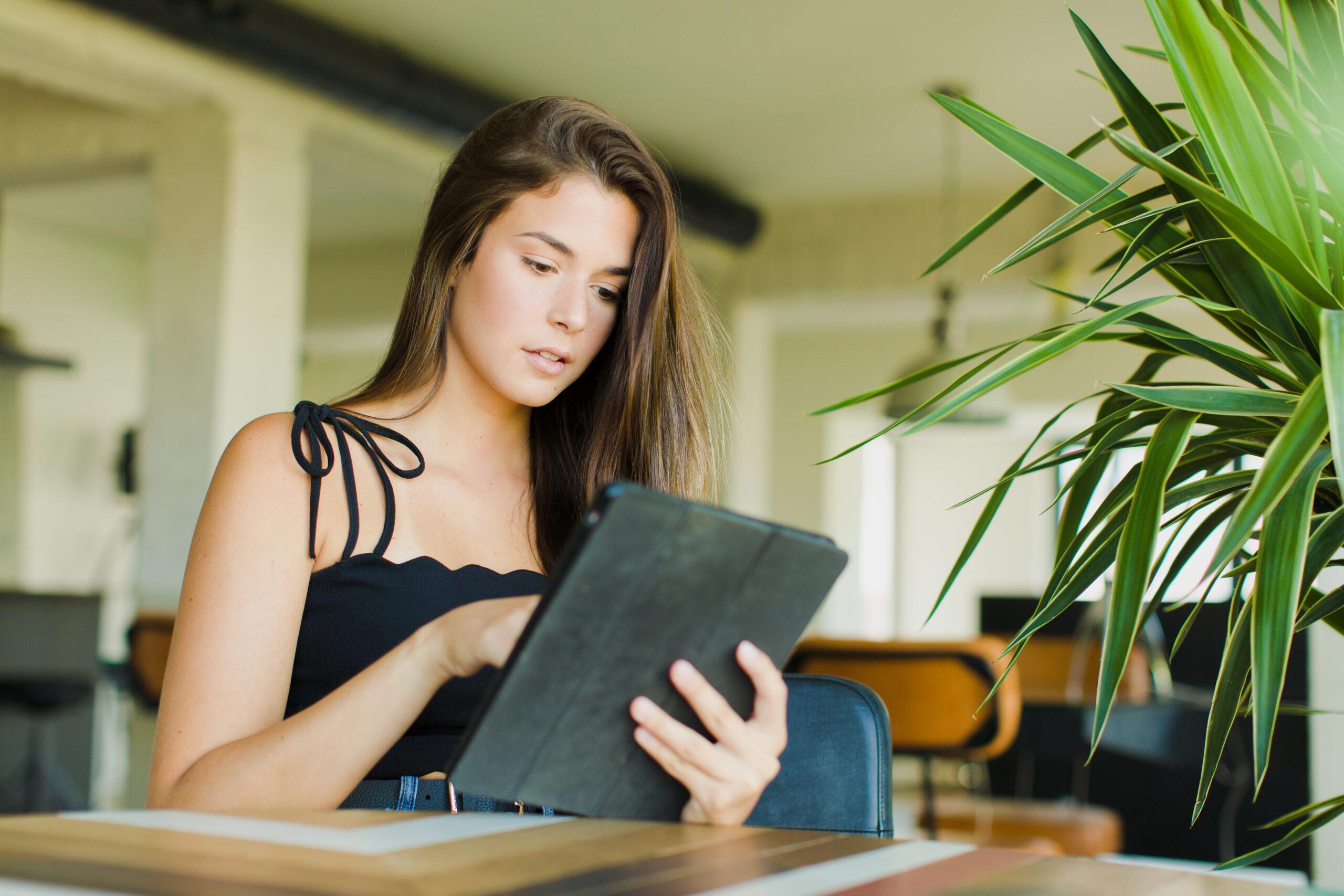 Young pretty woman at home using her tablet