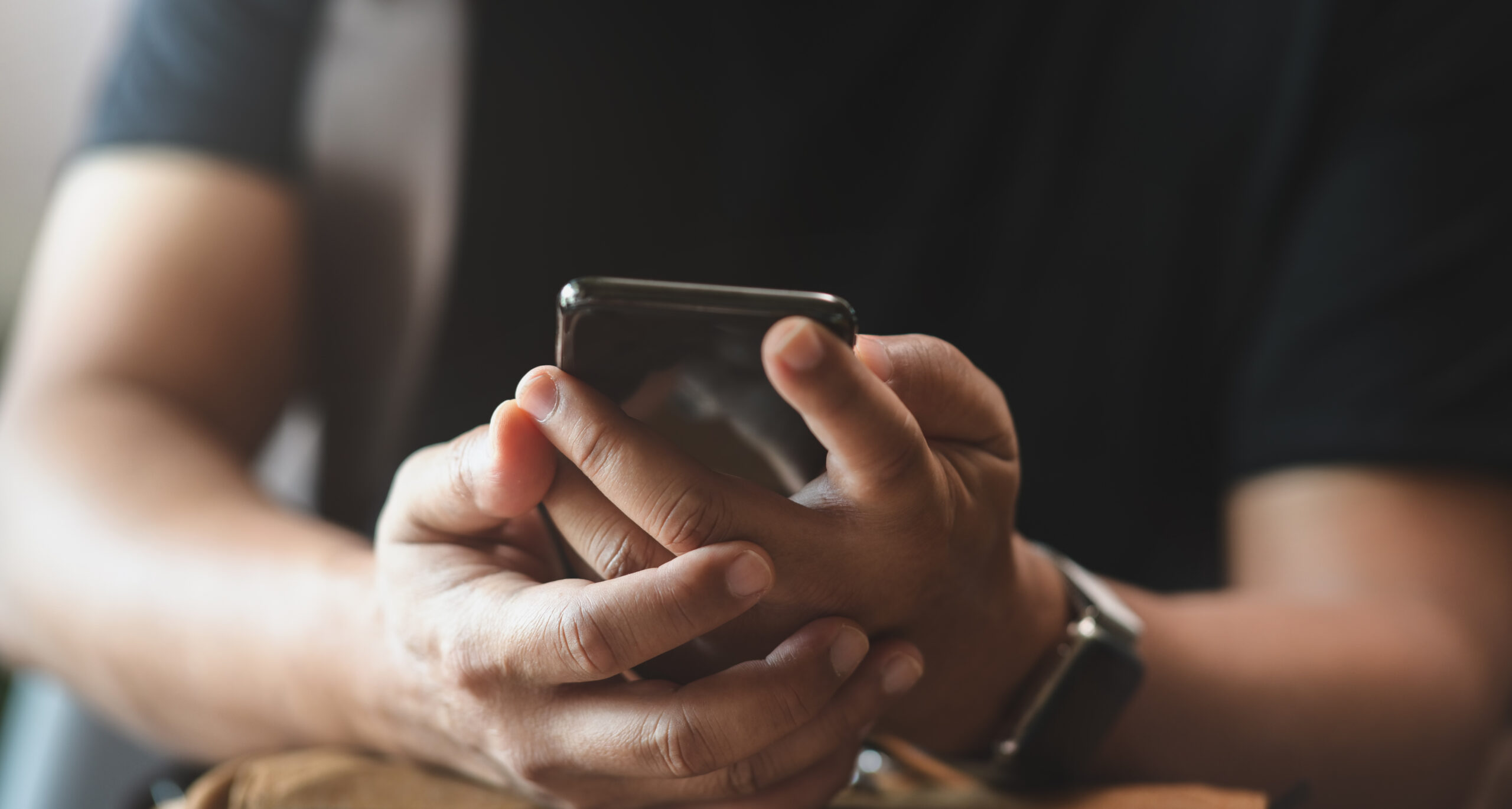 young man holding smartphone