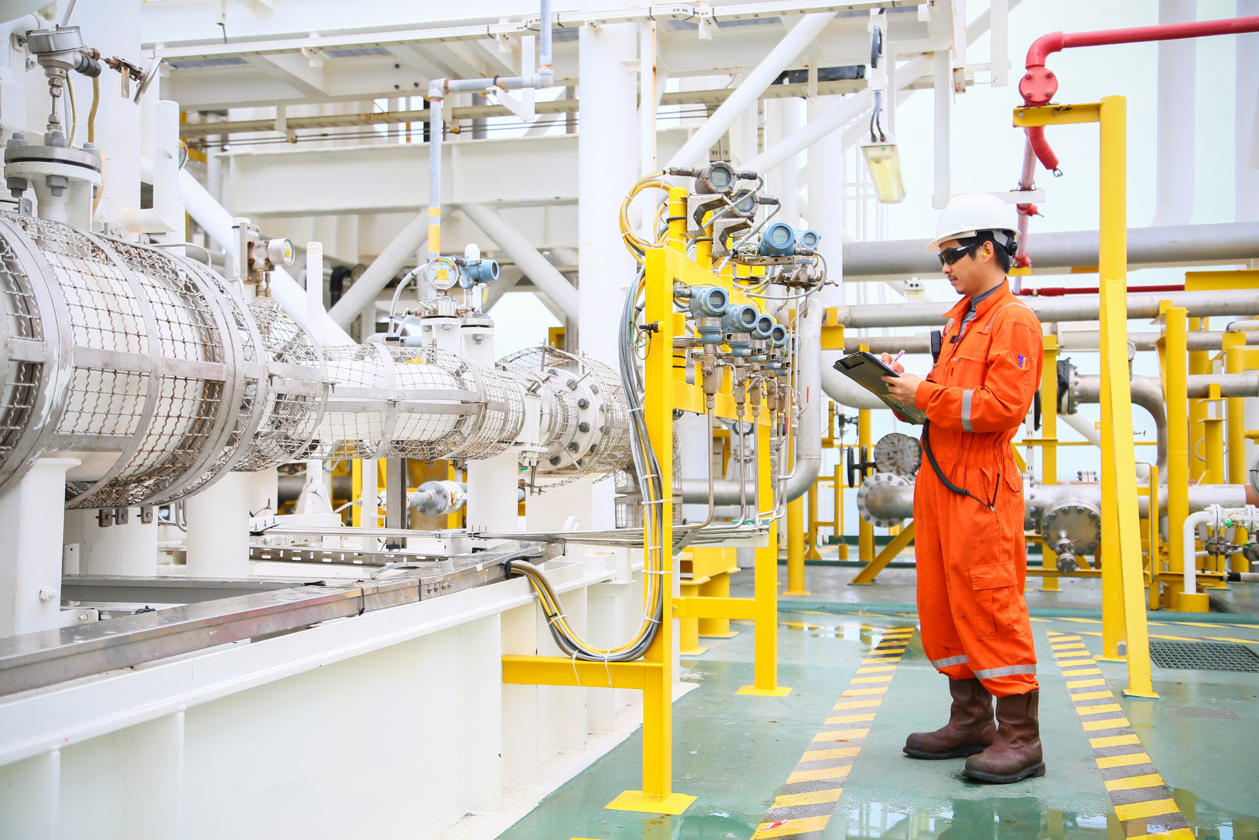 operator recording operation of oil and gas process at offshore oil rig in an area that does not allow cell phones.