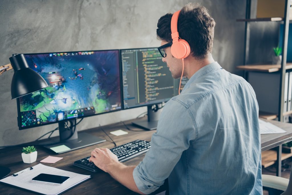 Man playing a video game using his personal computer.