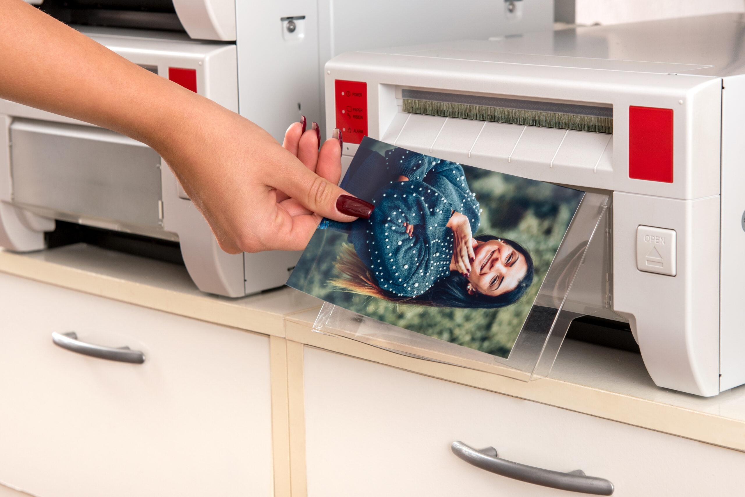 Woman taking a print of a woman from a printer