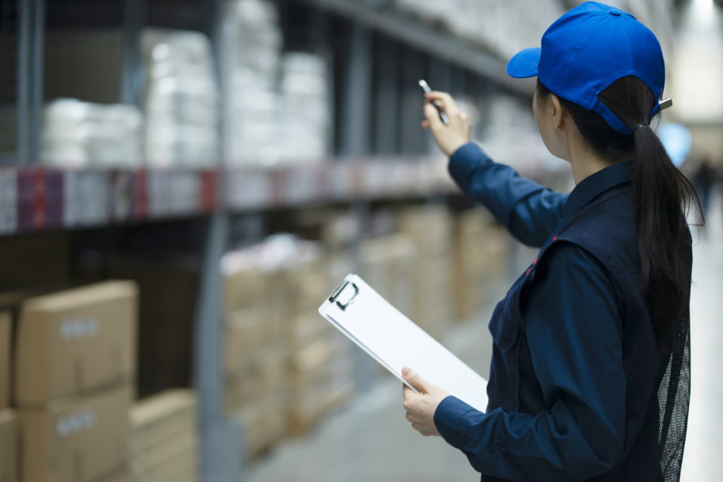 Warehouse worker checking inventory in logistics warehouse
