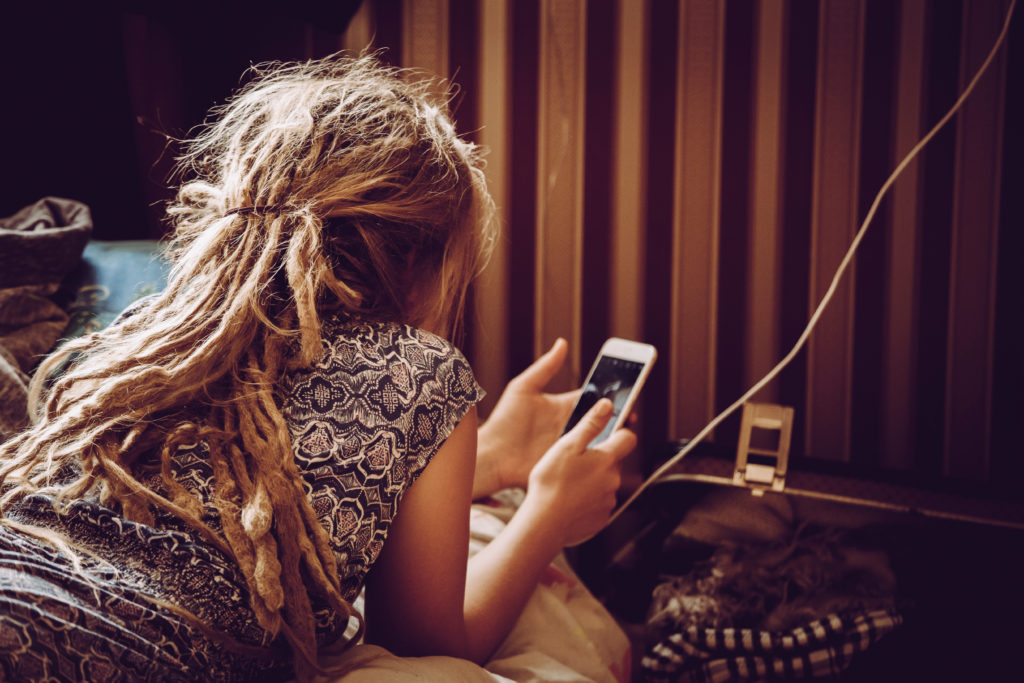 Woman using her phone while charging