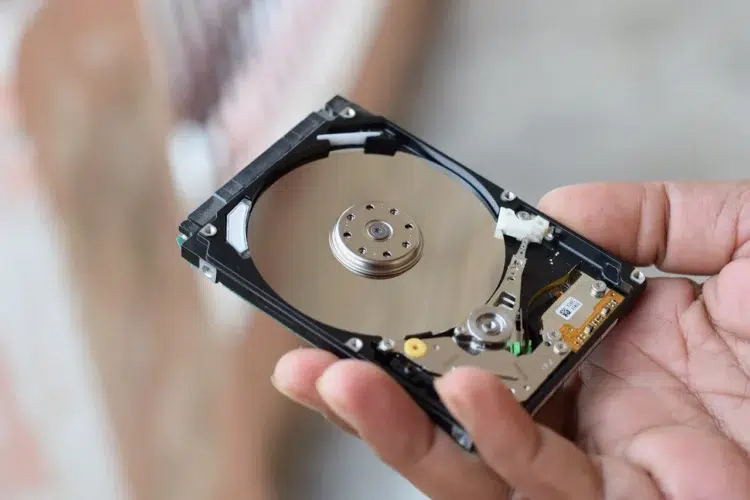 Man holding storage parts for building an expensive custom computer.