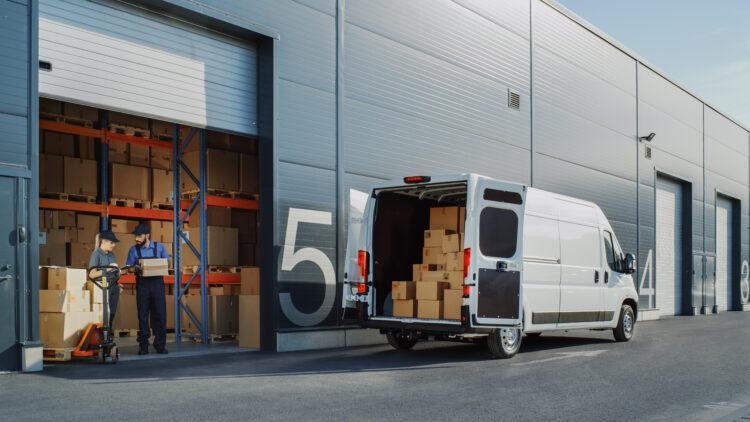 delivery van loading outside of logistics warehouse