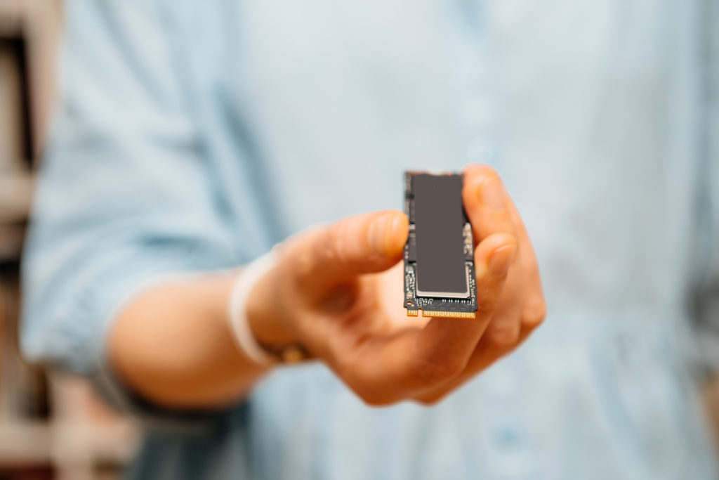 Woman holding fast NVME ssd disk drive