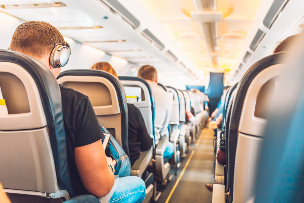 Passengers boarded in economy class of aircraft.