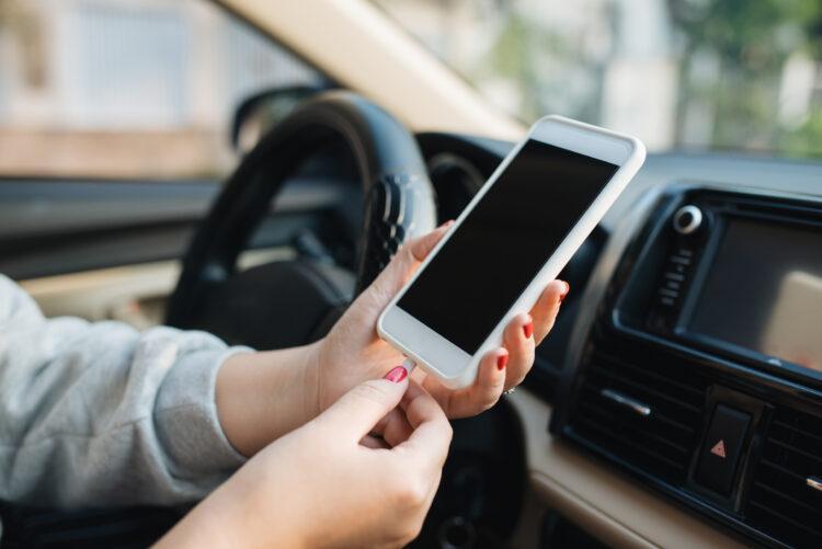 Woman charging phone inside the car