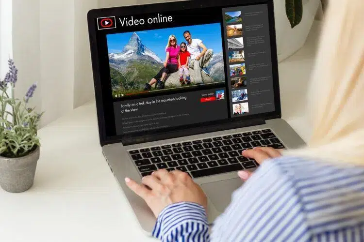 Woman watching videos online on laptop