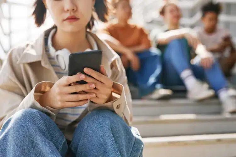 frowning young woman looking at her smartphone