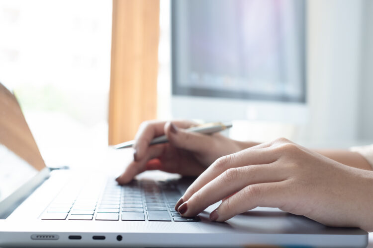 woman hands on computer keyboard