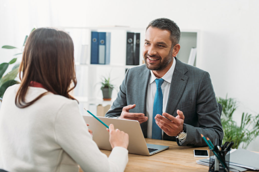 Advisor discussing with a woman inside the office.