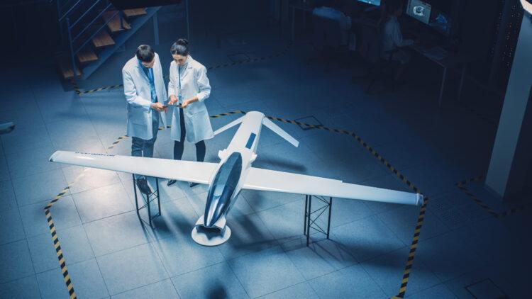 Two Aerospace Engineers Work On Unmanned Aerial Vehicle / Drone Prototype 