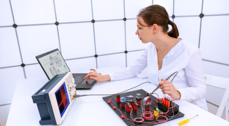 Young student is experimenting with a laser measurement system for the optical properties of substances in a physics laboratory