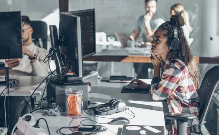 Young female programmer looking intently at the computer monitor