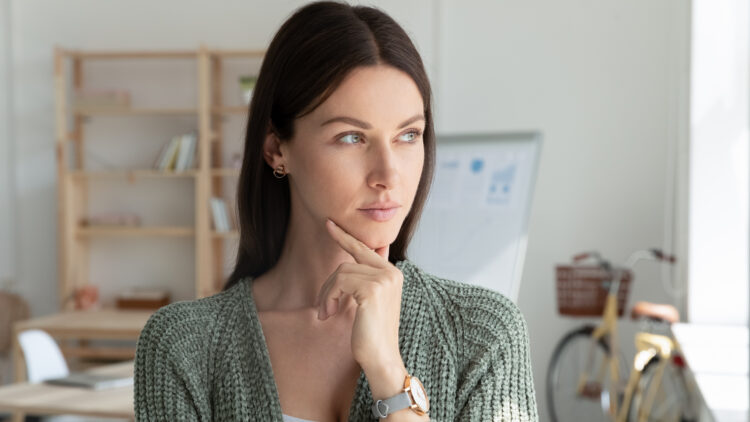 confident attractive mentor woman holding chin thinking