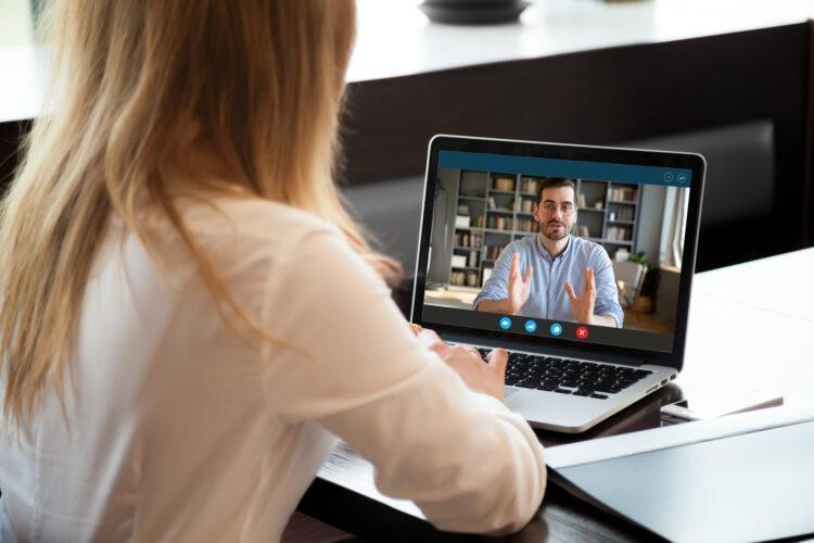 Employer listening to applicant during job online interview
