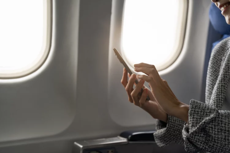 Woman using smartphone in aircraft