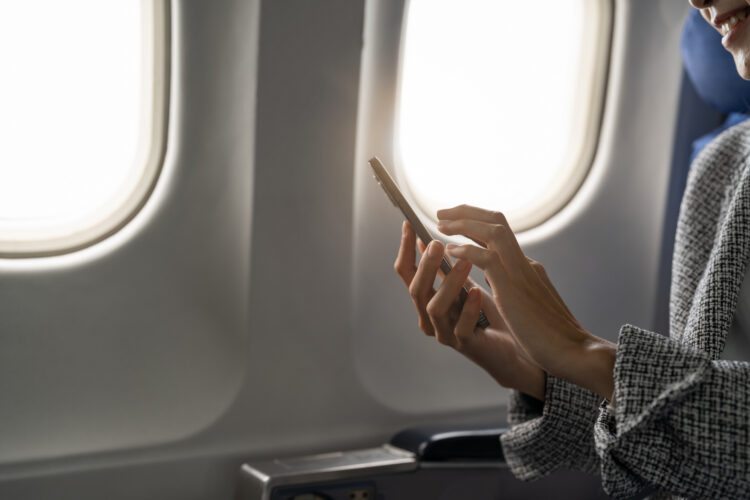 Woman using smartphone in aircraft