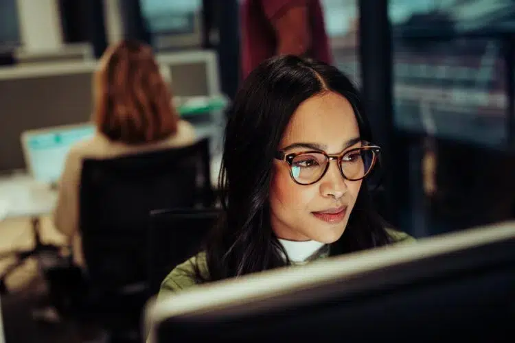 Woman working on desktop looking up how to get personal files off a work computer.