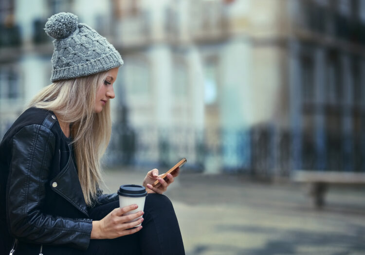 attractive woman using a mobile phone in the city.