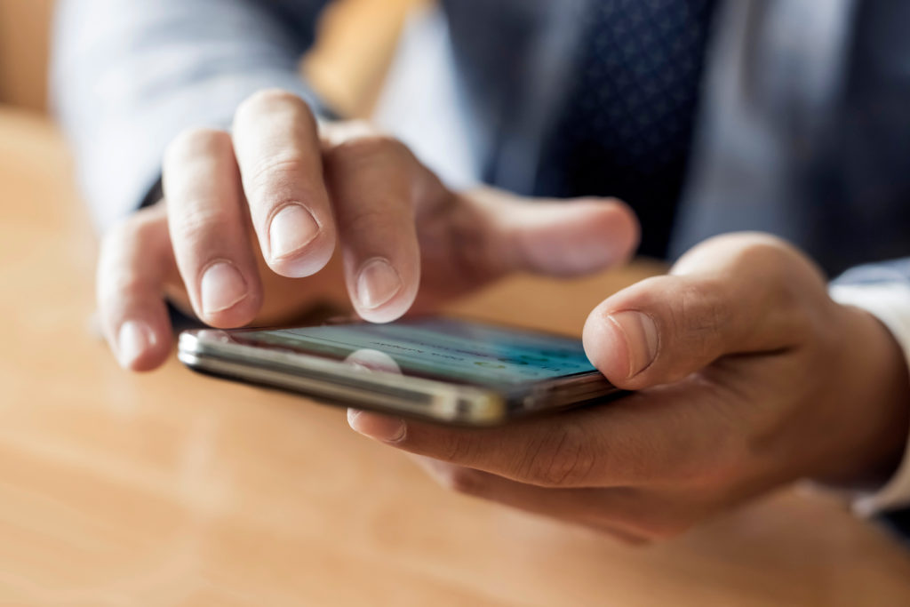 Man using his smartphone at a desk