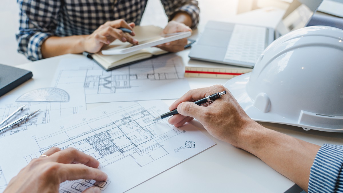 engineer drawing plan on blueprint with architect equipment