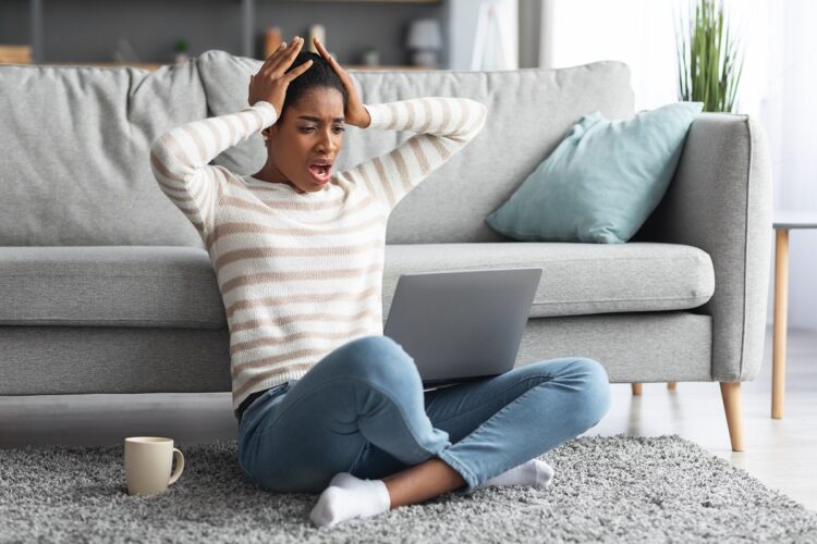 frustrated woman suffering issues with laptop at home