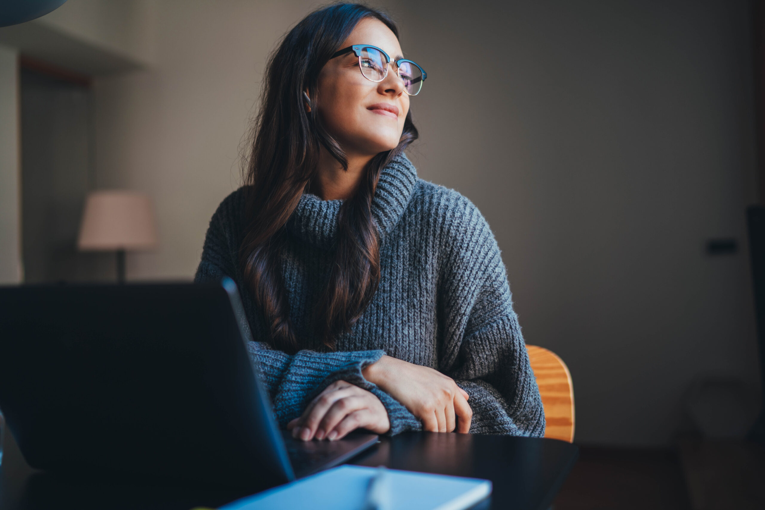 Happy attractive young woman working in modern office using lapt