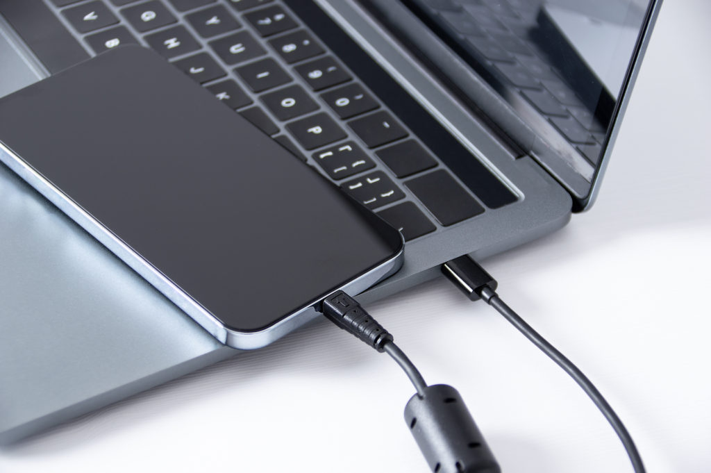Smartphone to laptop for data dump via USB cable.
