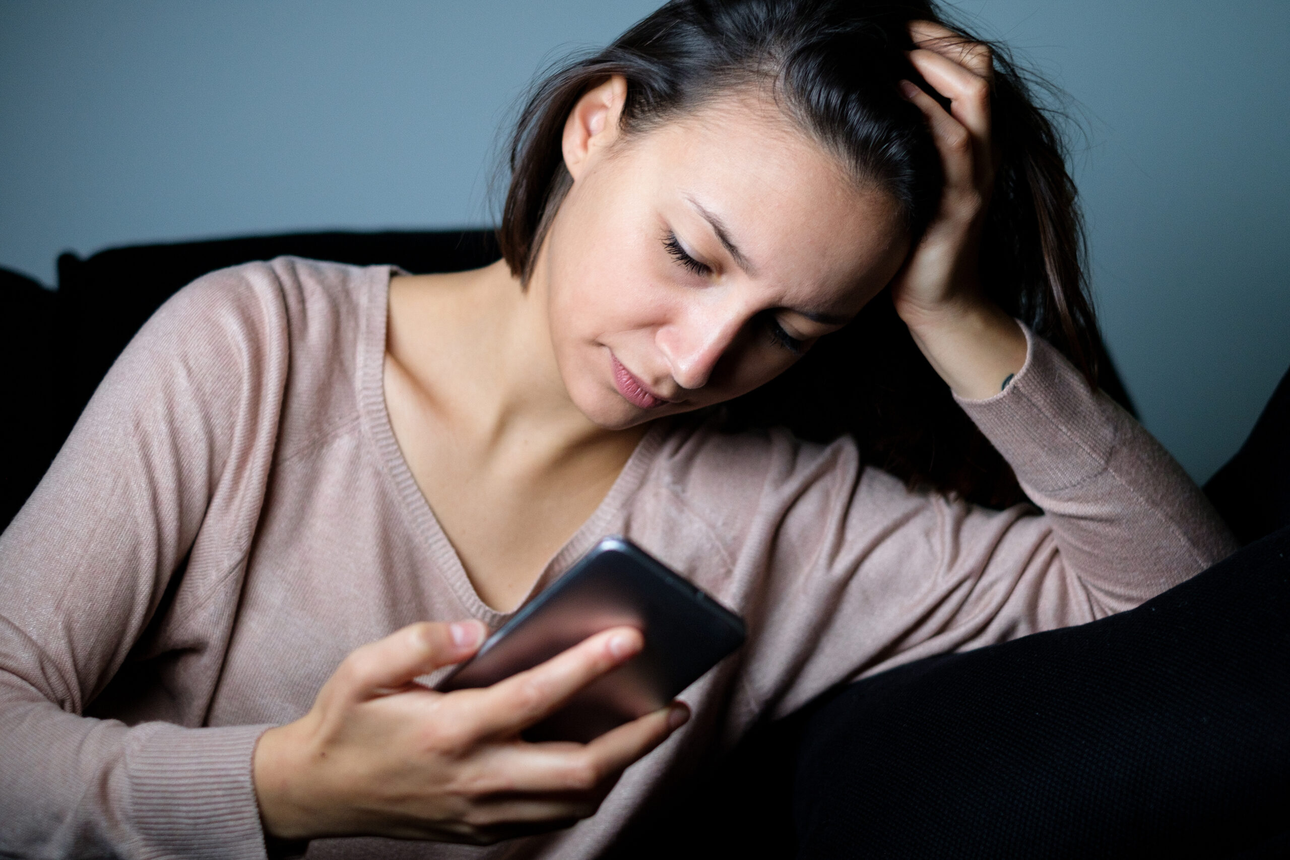 Sad woman discovering boyfriend betrayal phone message