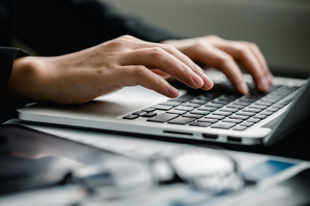 Office employee working on the laptop computer.