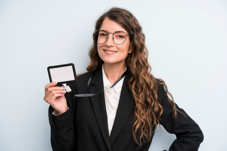 young pretty woman showing security badge.