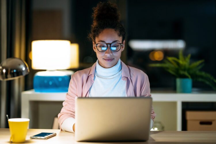 young woman working with laptop sitting in the office