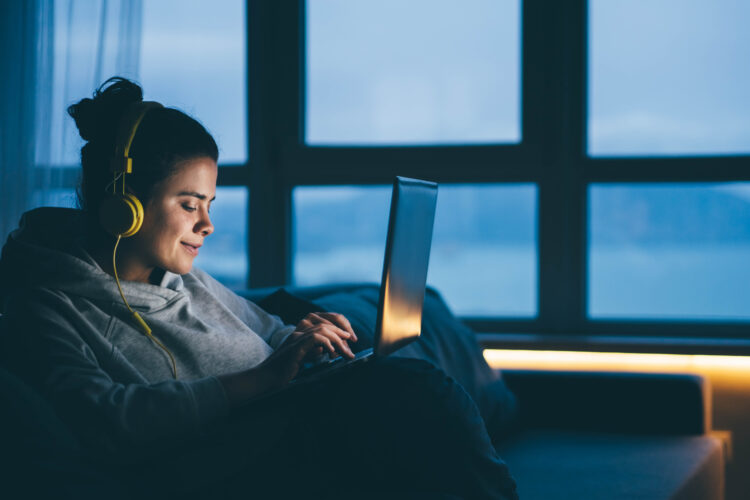 Woman using laptop and internet connection at home.