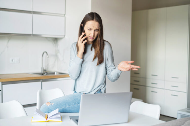 Annoyed young woman talks on the smartphone