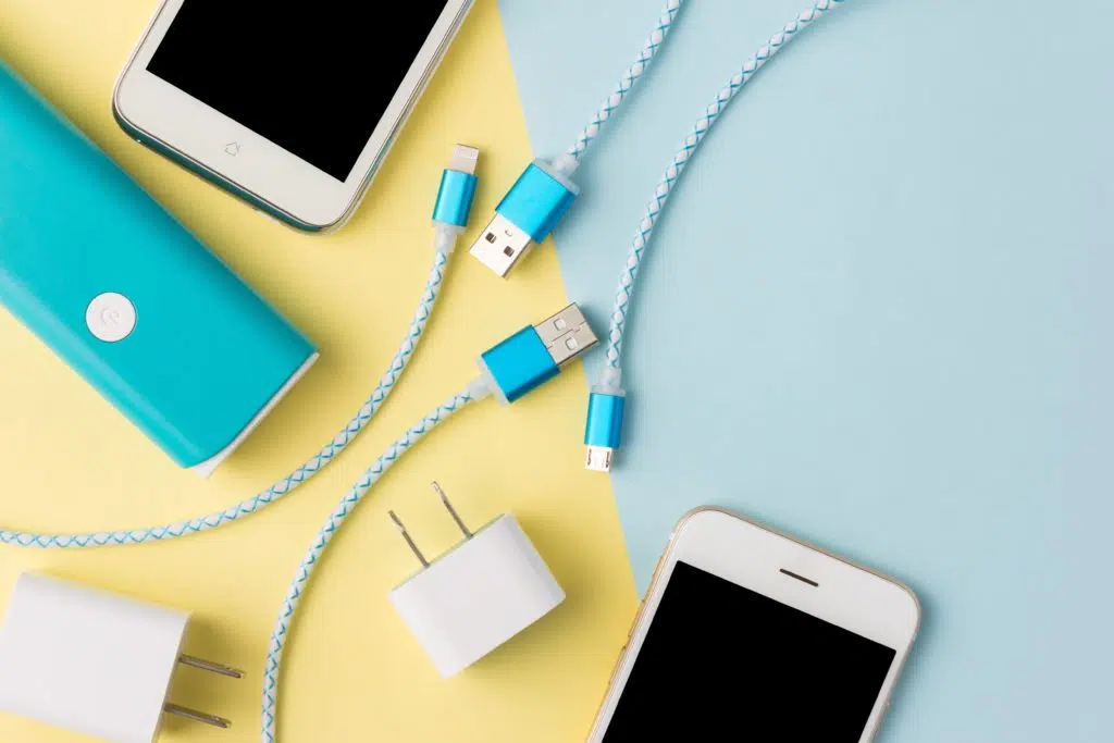 Blue USB charging cables with adapter and phones.