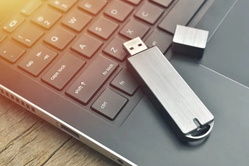 Metal USB flash drive on a laptop that can be used to copy files off the computer without leaving a trace.