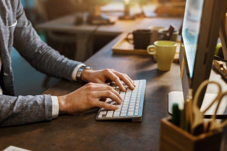 man searching or looking up online using computer