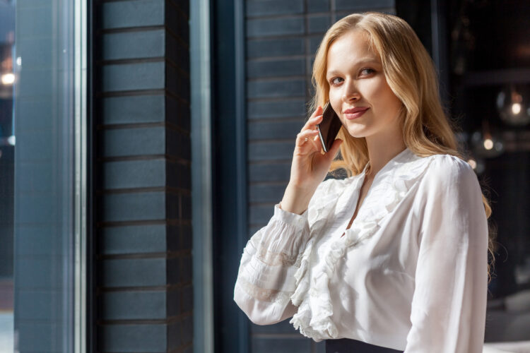 woman making a phone call outside the building